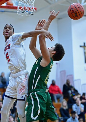 WARREN, OHIO - JANUARY 2, 2017: JFK's Tyler blocks the shot of Ursuline's Ryan Clark during the first half of their game on Tuesday night at Warren JFK High School. DAVID DERMER | THE VINDICATOR