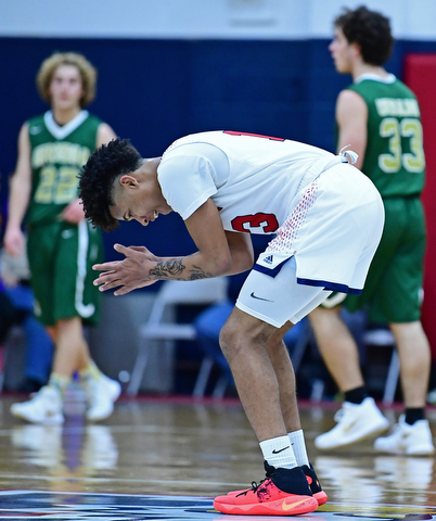 WARREN, OHIO - JANUARY 2, 2017: JFK's Hyland Burton claps his hands and smiles in celebration after hitting a three point shot and forcing Ursuline to call a time out during the first half of their game on Tuesday night at Warren JFK High School. DAVID DERMER | THE VINDICATOR