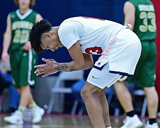 WARREN, OHIO - JANUARY 2, 2017: JFK's Hyland Burton claps his hands and smiles in celebration after hitting a three point shot and forcing Ursuline to call a time out during the first half of their game on Tuesday night at Warren JFK High School. DAVID DERMER | THE VINDICATOR