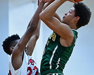 WARREN, OHIO - JANUARY 2, 2017: Ursuline's Ryan Clark goes to the basket against JFK's Ethan Courtney during the first half of their game on Tuesday night at Warren JFK High School. DAVID DERMER | THE VINDICATOR