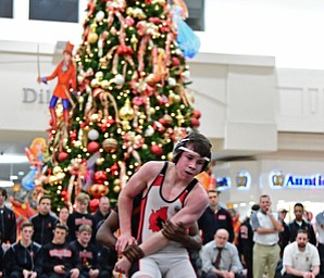 NILES, OHIO - JANUARY 3, 2018: Canfield's Nick Barber attempts to break free from the grasp of Howland's Dylan Shields during their 106lb bout, Wednesday nigh at the Eastwood Mall. DAVID DERMER | THE VINDICATOR