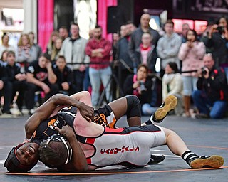 NILES, OHIO - JANUARY 3, 2018: Howland's Isaiah Lyles attempts to work Canfield's Chris Mauch onto his back during their 120lb bout, Wednesday nigh at the Eastwood Mall. DAVID DERMER | THE VINDICATOR