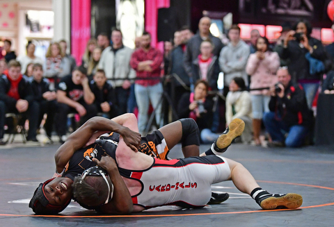 NILES, OHIO - JANUARY 3, 2018: Howland's Isaiah Lyles attempts to work Canfield's Chris Mauch onto his back during their 120lb bout, Wednesday nigh at the Eastwood Mall. DAVID DERMER | THE VINDICATOR