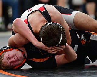 NILES, OHIO - JANUARY 3, 2018: Howland's Tyler Copeland fights to avoid being rolled over by Canfield's Vince Agostinelli during their 126lb bout, Wednesday nigh at the Eastwood Mall. DAVID DERMER | THE VINDICATOR