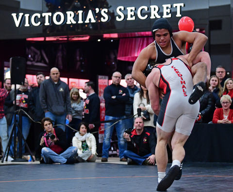 NILES, OHIO - JANUARY 3, 2018: Howland's Brandon Matlock fights to avoid being taken down by Canfield's Tyler Stein during their 220lb bout, Wednesday nigh at the Eastwood Mall. DAVID DERMER | THE VINDICATOR