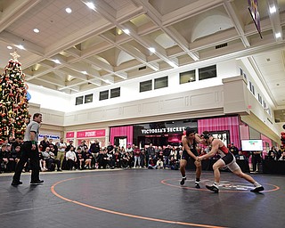 NILES, OHIO - JANUARY 3, 2018: Howland's Brandon Matlock and Canfield's Tyler Stein grapple during their 220lb bout, Wednesday nigh at the Eastwood Mall. DAVID DERMER | THE VINDICATOR