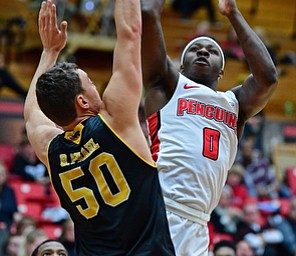 YOUNGSTOWN, OHIO - JANUARY 4, 2017: Youngstown State's Tyree Robinson shoots over Milwaukee's Brett Brahl during the first half of their game, Thursday night at Beeghly Center. DAVID DERMER | THE VINDICATOR