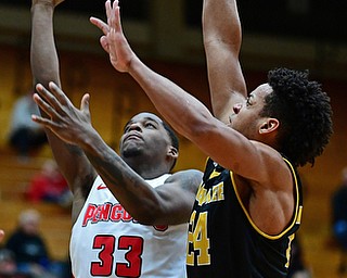 YOUNGSTOWN, OHIO - JANUARY 4, 2017: Youngstown State's Naz Bohannon goes to the basket against Milwaukee's Bryce Nze during the first half of their game, Thursday night at Beeghly Center. DAVID DERMER | THE VINDICATOR