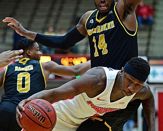 YOUNGSTOWN, OHIO - JANUARY 4, 2017: Youngstown State's Tyree Robinson falls while driving on Milwaukee's Vance Johnson during the first half of their game, Thursday night at Beeghly Center. DAVID DERMER | THE VINDICATOR