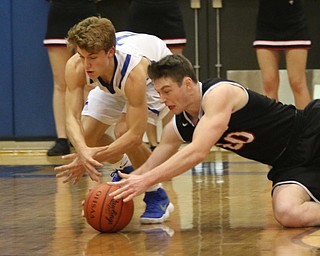 Ryan Leonard (20) of Struthers dives for a loose ball with Mike Diaz (2) of Poland during the second half of Thursday nights matchup at Poland High School.   Dustin Livesay  |  The Vindicator  1/4/18  Poland.