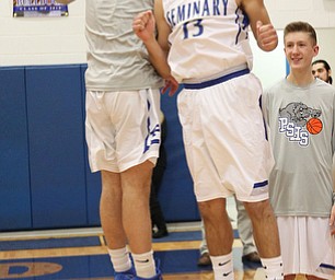 Poland's Brandon Barringer (13) celebrates with a teammate after Thursday nights matchup against Struthers at Poland High School.    Dustin Livesay  |  The Vindicator  1/4/18  Poland.