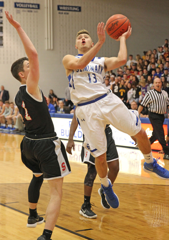 Brandon Barringer (13) of Poland goes up for a shot while being defended by Issiah Torrence (1) of Struthers during the second half of Thursday nights matchup at Poland High School. Dustin Livesay  |  The Vindicator  1/4/18  Poland