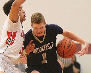 William D Lewis the vindicator  Brookfield's Conner Stevens(1) ) drives around Girard's Anthony Backus(3)) during 1-5-18 action at Girard