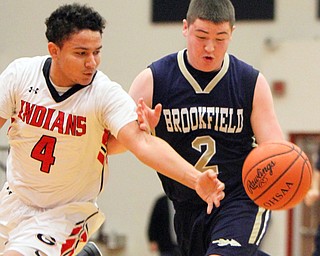 William D Lewis the vindicator  Brookfield'sNate Smoot(2) drives around Girard's David Blackmon(4) during 1-5-18 action at Girard