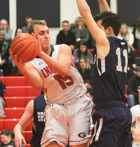 William D Lewis the vindicator  Girard's Mark Waid(15) passes around Brookfield's Abe Rasoul(11) during 1-5-18 action at Girard