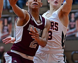 HOWLAND, OHIO - JANUARY 5, 2018: Boardman's Ryan Archey goes to the basket against Howland's Che Trevena during the first half of their game, Friday night at Howland HigH School. DAVID DERMER | THE VINDICATOR