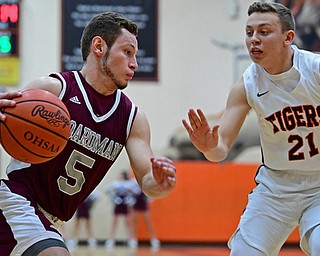 HOWLAND, OHIO - JANUARY 5, 2018: Boardman's Mike Melewski drives on Howland's Frankie Manios during the first half of their game, Friday night at Howland HigH School. DAVID DERMER | THE VINDICATOR