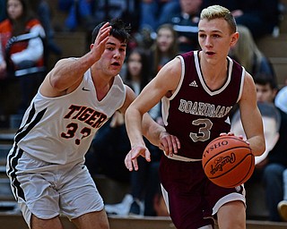 HOWLAND, OHIO - JANUARY 5, 2018: Boardman's Holden Lipke drives on Howland's Kevin Moamis during the first half of their game, Friday night at Howland HigH School. DAVID DERMER | THE VINDICATOR