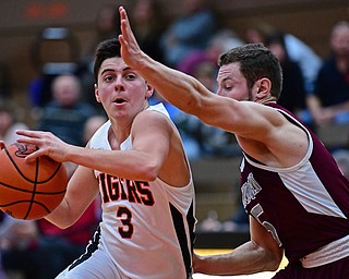 HOWLAND, OHIO - JANUARY 5, 2018: Howland's Frank Rappach drives on Boardman's Mike Melewski during the second half of their game, Friday night at Howland HigH School. DAVID DERMER | THE VINDICATOR