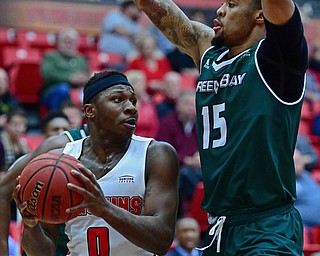 YOUNGSTOWN, OHIO - JANUARY 6, 2017: Youngstown State's TJ Parham looks to pass while being pressured by Green Bay's Manny Patterson during the first half of their game, Saturday night at Beeghly Center. DAVID DERMER | THE VINDICATOR