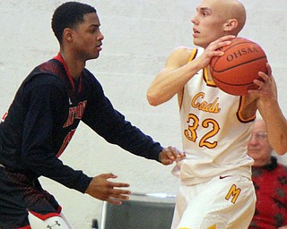 William D. Lewis The Vindicator Mooney's Jonnie Mikos(32) keeps the ball from JFK's  Byron Taylor(12)