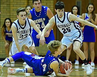 McDONALD, OHIO - JANUARY 9, 2018: Western Reserve's Kade Hilles secures the ball before calling for a timeout after falling to the floor while being pressured by McDonald's Zack Rasile and Rico Rodriguez during the second half of their game, Tuesday night at McDonald High School. DAVID DERMER | THE VINDICATOR