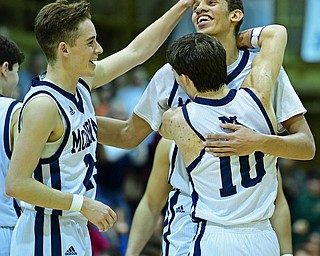 McDONALD, OHIO - JANUARY 9, 2018: McDonald's Braedon Poole is congratulated by Rico Rodriguez and Josh Celli after scoring his 1000th career point during the second half of their game, Tuesday night at McDonald High School. DAVID DERMER | THE VINDICATOR