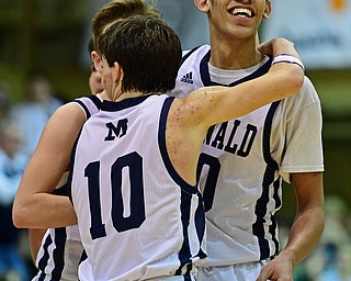 McDONALD, OHIO - JANUARY 9, 2018: McDonald's Braedon Poole is congratulated by Rico Rodriguez and Josh Celli after scoring his 1000th career point during the second half of their game, Tuesday night at McDonald High School. DAVID DERMER | THE VINDICATOR