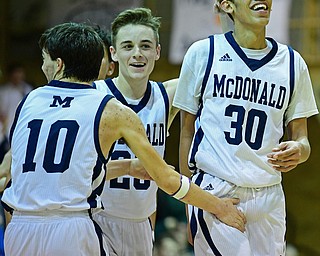 McDONALD, OHIO - JANUARY 9, 2018: McDonald's Braedon Poole is congratulated by Rico Rodriguez and Josh Celli after scoring his 1000th career point during the second half of their game, Tuesday night at McDonald High School. DAVID DERMER | THE VINDICATOR