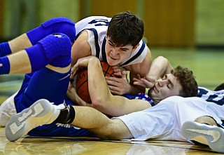 McDONALD, OHIO - JANUARY 9, 2018: Western Reserve's Cole DeZee attempts to secure the ball while laying on top of McDonald's Josh Celli while Zack Rasile attempts to rip the ball free during the second half of their game, Tuesday night at McDonald High School. DAVID DERMER | THE VINDICATOR