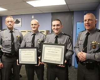 Showing the certificates of recognition given to troopers Daniel Deluca and Benjamin Miller by the Ohio State Highway Patrol for saving an 11-year-old boy from choking are, from left, OSHP Capt. Eric Sheppard, Deluca and Miller, and post commander Lt. Jerard Sutton. 