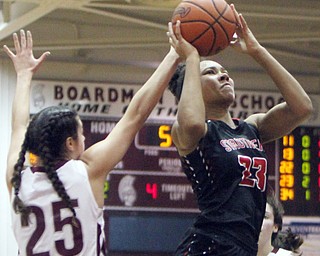 William D. Lewis  The Vindicator  Struthers Trinity McDowell(23) shoots past Boardman's (25) during 1-10-18 action at Boardman