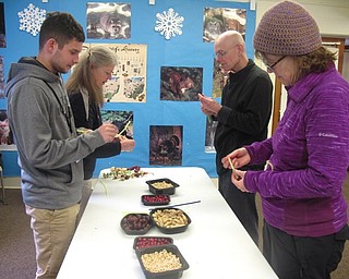 Neighbors | Zack Shively.One of the feeders the guests made for the "Joy to the Birds" event used pipe cleaner to string together Cheerios, peanuts and fruit.