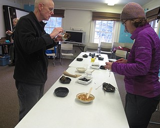 Neighbors | Zack Shively.Participants in the Ford Nature Center's "Joy to the Birds" event made another feeder where they tied string to the top of a pinecone and covered it in lard and peanut butter and covered it in sunflower seeds.
