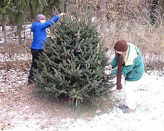 Neighbors | Zack Shively.After making bird feeders, the participants of "Joy to the Birds" placed the feeders on the tree outside of the Ford Nature Center for the overwinter birds to eat. Some took feeders home with them to feed the birds at their homes.