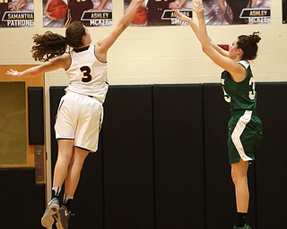 Ursuline's Lindsay Bell (35) goes up for three as South Range's Izzy Lamparty (3) attempts to block her shot in the first half of an OSHAA girls high school basketball game, Thursday, Jan. 11, 2018, in Canfield. South Range won 54-49...(Nikos Frazier | The Vindicator)