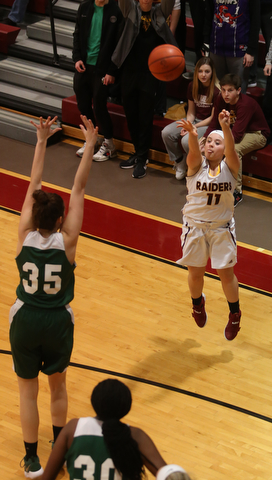 South Range's Bri Modic (11) goes up for three as Ursuline's Lindsay Bell (35) attempts to block her shot in the second half of an OSHAA girls high school basketball game, Thursday, Jan. 11, 2018, in Canfield. South Range won 54-49...(Nikos Frazier | The Vindicator)