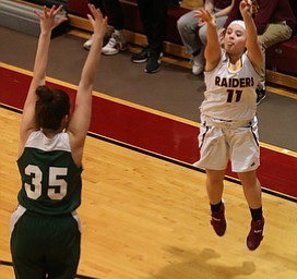 South Range's Bri Modic (11) goes up for three as Ursuline's Lindsay Bell (35) attempts to block her shot in the second half of an OSHAA girls high school basketball game, Thursday, Jan. 11, 2018, in Canfield. South Range won 54-49...(Nikos Frazier | The Vindicator)