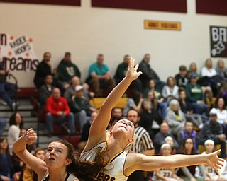 South Range's Bree Kohler (12) falls onto Ursuline's Cara McNally (5) under the basket in the second half of an OSHAA girls high school basketball game, Thursday, Jan. 11, 2018, in Canfield. South Range won 54-49...(Nikos Frazier | The Vindicator)
