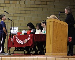 Neighbors | Abby Slanker.A Canfield Village Middle School student took his turn at the microphone and looked to Professor Wendy Pfrenger of Kent State Salem to pronounce his word to spell during the school’s annual Spelling Bee on Dec. 21.