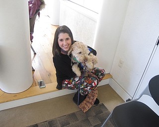 Neighbors | Zack Shively.Pictured is Dana Patrick and her dog, Reese, at the "Read to Reese" event at the Austintown library on Dec. 9. Patrick works as a second-grade teacher at Austintown Elementary School and her dog has been certified as a therapy dog. They help children read better independently through their monthly program.