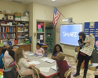 Neighbors | Zack Shively.Market Street Elementary School offers Spanish classes after school for students who want to learn the language. Pictured, instructor Enid Maldonado reviewed the Spanish alphabet with the students.