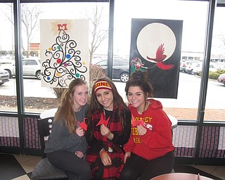 Neighbors | Zack Shively.Cardinal Mooney's art students made decorations to be displayed in the Starbucks windows during the school's take over of Barnes and Noble. Volunteers also made red origami birds to give to shoppers. Pictured are, from left, Maeghan Williams, Katie Enright and Lugina Bassil.