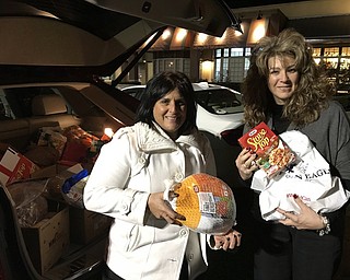 GFWC Ohio Warren Junior Women’s domestic-violence awareness committee adopted a family in Trumbull County for the holidays. Above, Jonnah Hetzel, left, president, and Mary Swift, chairwoman, delivered a full Thanksgiving dinner, a Christmas tree and a few presents to brighten a family’s holiday. 
