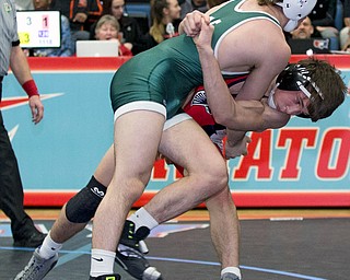 ALLIANCE, OHIO - JANUARY 10, 2018: TOP GUN WRESTLING- Austintown's Wes Sutton (red) has his opponent  Musselman's Joey Miller's (green) in his grasp during the 126 lbs match at Alliance High School.  MICHAEL G TAYLOR | THE VINDICATOR