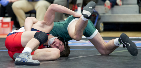 ALLIANCE, OHIO - JANUARY 10, 2018: TOP GUN WRESTLING- Austintown's Wes Sutton (red) makes the winning move against   Musselman's Joey Miller's (green) during OT in the championship 126 lbs match at Alliance High School.  MICHAEL G TAYLOR | THE VINDICATOR