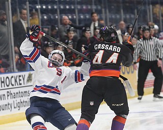 Youngstown Phantoms defenseman Gianfranco Cassaro (44) checks Team USA forward Jake Wise (12)  in the first period of an USHL regular season hockey game, Monday, Jan. 15, 2018, in Youngstown. Team USA won 7-1...(Nikos Frazier | The Vindicator)