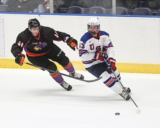 Youngstown Phantoms defenseman Gianfranco Cassaro (44) attempts to get the puck from Team USA forward Jack Hughes (43) in the first period of an USHL regular season hockey game, Monday, Jan. 15, 2018, in Youngstown. Team USA won 7-1...(Nikos Frazier | The Vindicator)