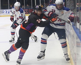 Youngstown Phantoms defenseman Steve Holtz (24) checks Team USA forward Gavin Hain (8) into the glass in the second period of an USHL regular season hockey game, Monday, Jan. 15, 2018, in Youngstown. Team USA won 7-1...(Nikos Frazier | The Vindicator)