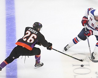 Youngstown Phantoms forward Matthew Barry (26) stretches out his stick to steal the puck from Team USA forward Jake Pivonka (20) in the third period of an USHL regular season hockey game, Monday, Jan. 15, 2018, in Youngstown. Team USA won 7-1...(Nikos Frazier | The Vindicator)